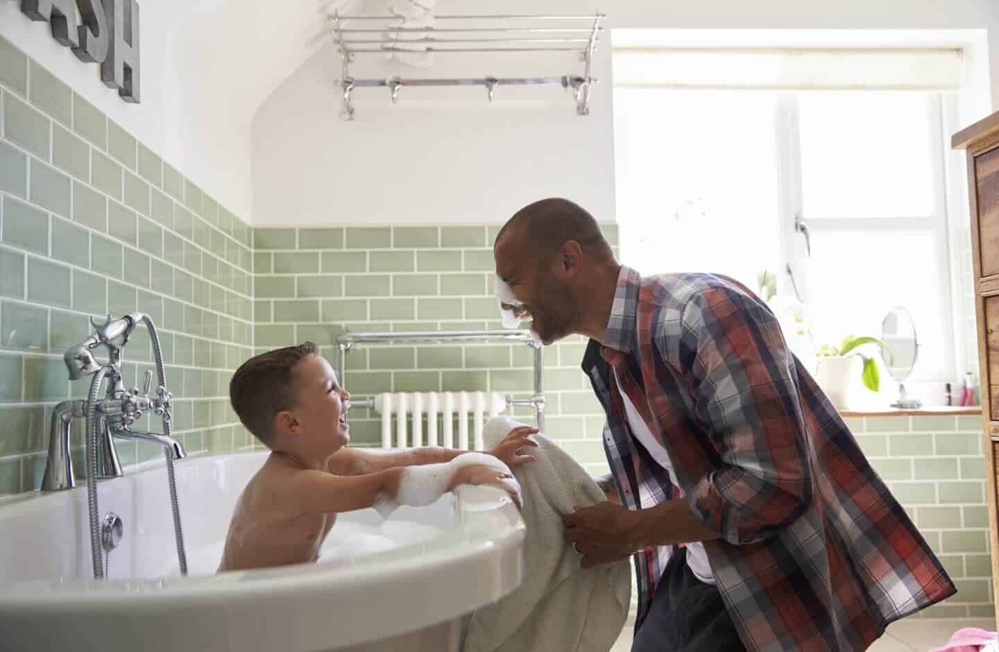 Dad giving healthier bath to son with home water softener system